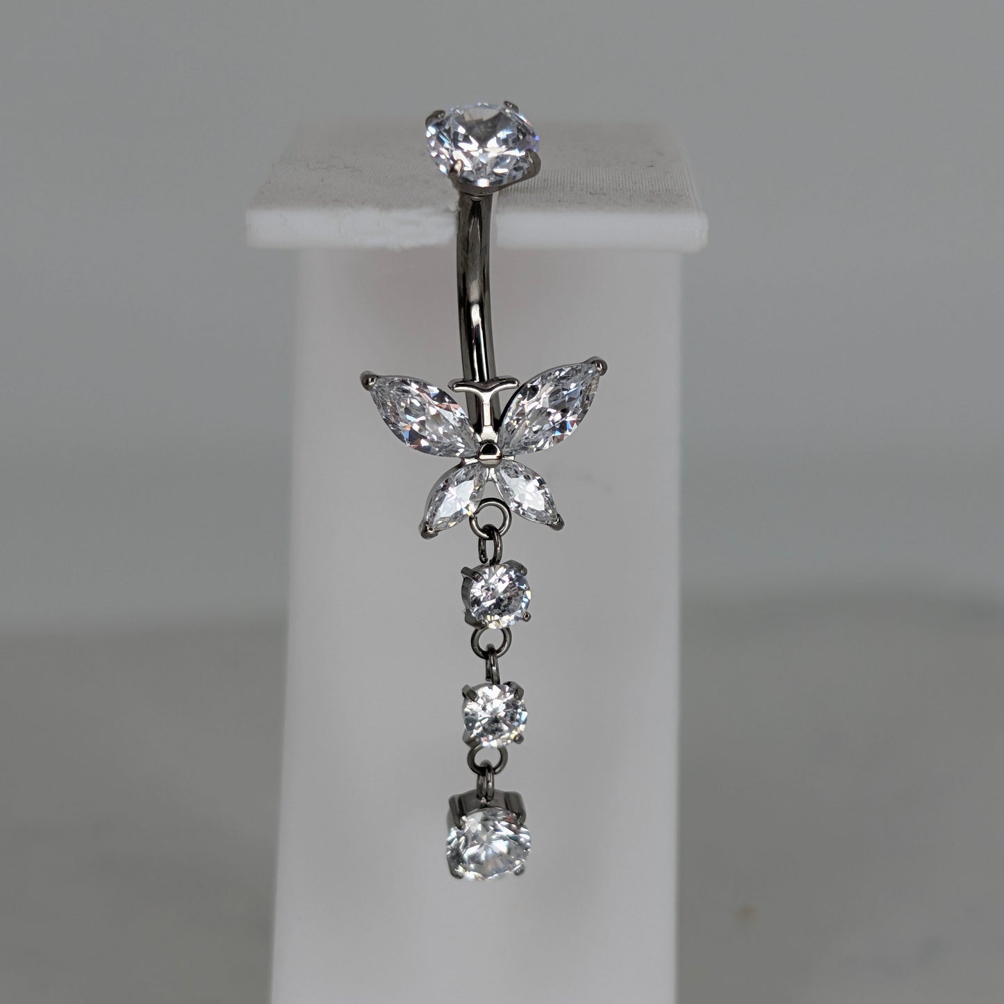 Dangling butterfly prong set navel bar
