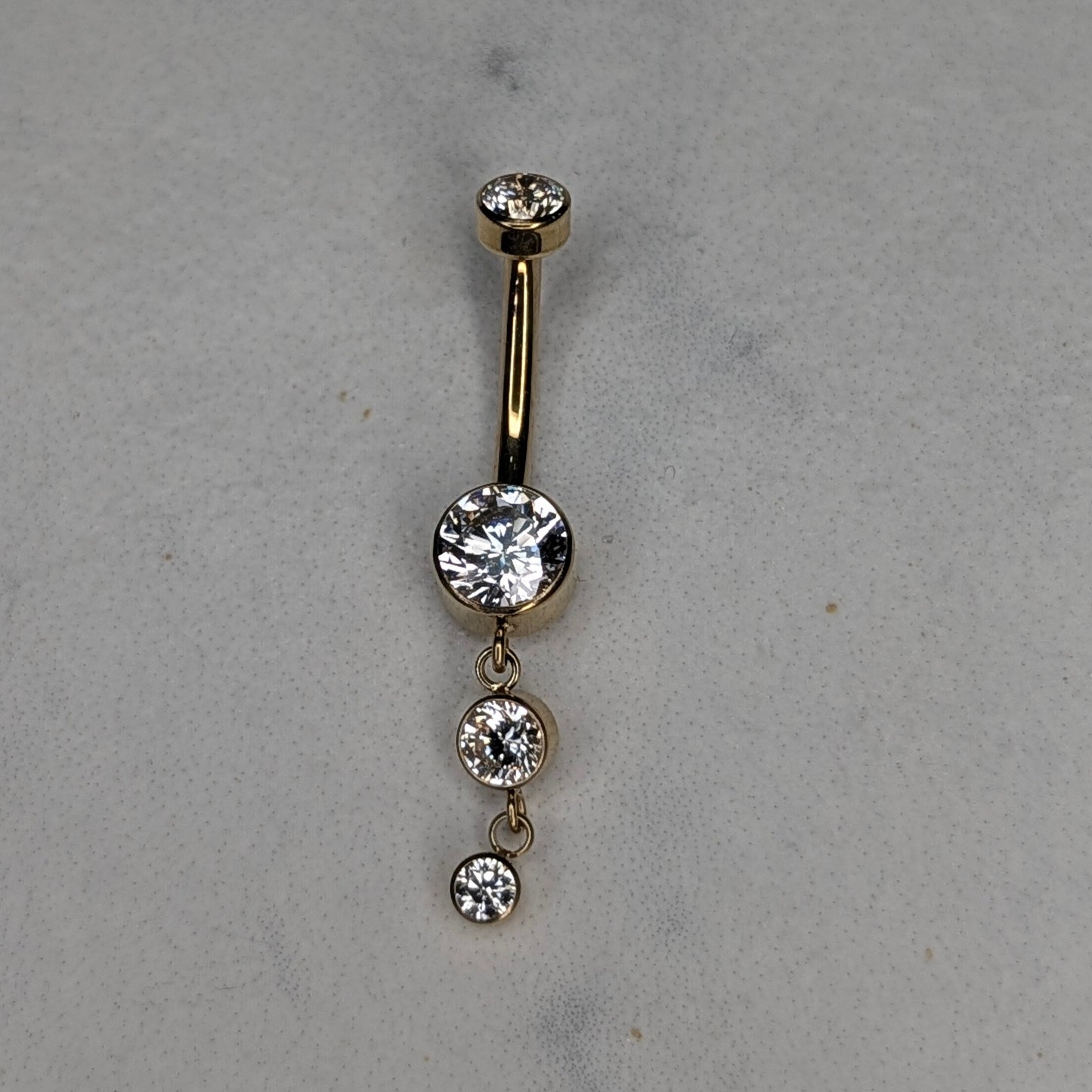 Dangling bezel navel bar PVD gold