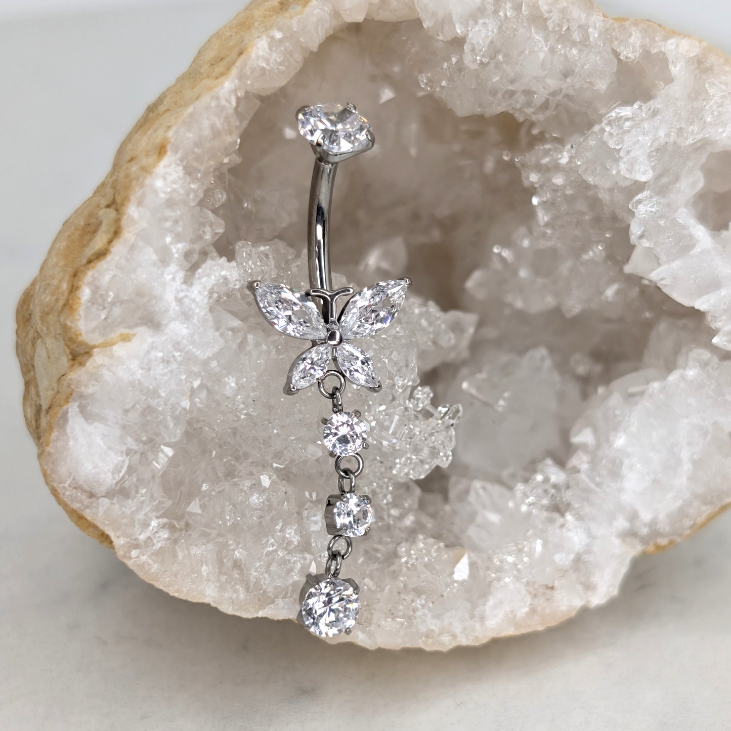 Dangling butterfly prong set navel bar